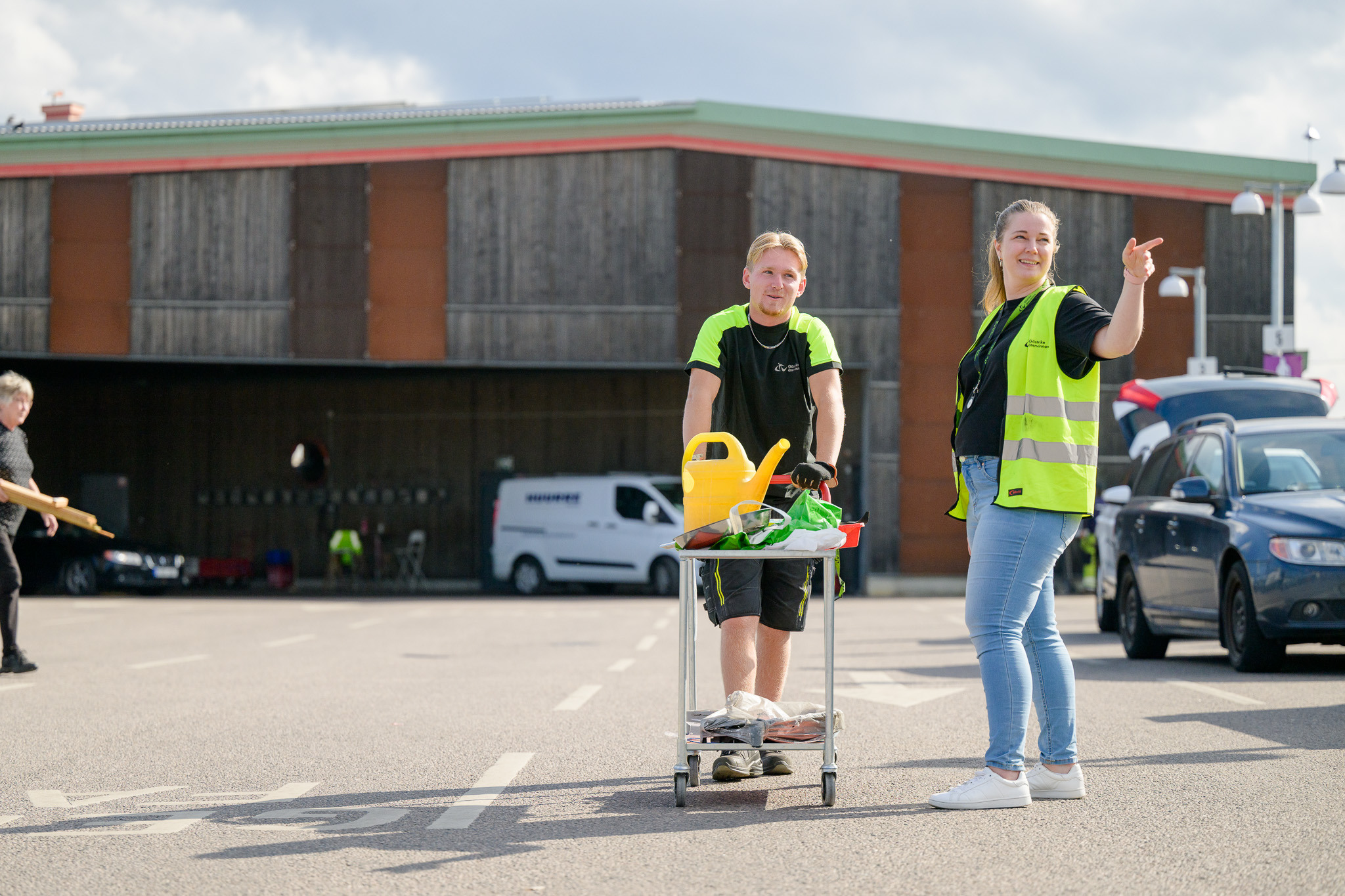 Man drar vagn med prylar på och kvinna pekar